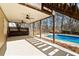 Covered back patio with ceiling fans, pool access, and landscaped yard at 5073 Kingsbridge Pass, Powder Springs, GA 30127