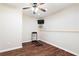 Finished basement with a treadmill, drop ceiling, and wood-look flooring at 5073 Kingsbridge Pass, Powder Springs, GA 30127