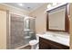 Updated bathroom with a tiled shower, modern vanity, and neutral decor at 5073 Kingsbridge Pass, Powder Springs, GA 30127