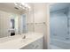 Well-lit bathroom featuring a vanity with a sink and a view into the adjacent shower and toilet space at 5073 Kingsbridge Pass, Powder Springs, GA 30127