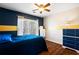 Stylish bedroom with a navy accent wall, wood floors, and a chest of drawers at 5073 Kingsbridge Pass, Powder Springs, GA 30127