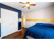 Bedroom featuring wood floors, closet, and adjacent access to the hall at 5073 Kingsbridge Pass, Powder Springs, GA 30127