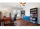 Bedroom with hardwood floors, a ceiling fan, a sewing desk and storage units at 5073 Kingsbridge Pass, Powder Springs, GA 30127