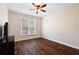 Cozy bedroom with a ceiling fan, wood-look floors, and a window at 5073 Kingsbridge Pass, Powder Springs, GA 30127