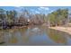 Picturesque lake with a fountain, walking path, and lush trees for a serene community setting at 5073 Kingsbridge Pass, Powder Springs, GA 30127