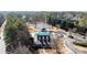 Overhead view of a covered community pool, tennis courts, and clubhouse at 5073 Kingsbridge Pass, Powder Springs, GA 30127