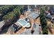 Aerial view of a neighborhood pool, tennis courts, and covered picnic area surrounded by mature trees at 5073 Kingsbridge Pass, Powder Springs, GA 30127