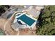 Aerial view of a covered pool, lounge area, and a paved parking lot at 5073 Kingsbridge Pass, Powder Springs, GA 30127