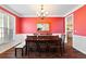 A dining room featuring hardwood floors, crown molding and adjacent kitchen access at 5073 Kingsbridge Pass, Powder Springs, GA 30127