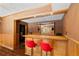 Basement bar area with wood accents, red barstools, and recessed lighting at 5073 Kingsbridge Pass, Powder Springs, GA 30127