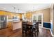 Eat-in kitchen featuring stainless appliances, tile backsplash, and wood floors at 5073 Kingsbridge Pass, Powder Springs, GA 30127