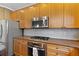 Spacious kitchen featuring stainless steel microwave, oven and refrigerator and granite countertops at 5073 Kingsbridge Pass, Powder Springs, GA 30127