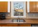 Kitchen sink with a view of trees and an umbrella outside the window at 5073 Kingsbridge Pass, Powder Springs, GA 30127