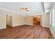 Open living room featuring hardwood floors, a ceiling fan, and elegant French doors at 5073 Kingsbridge Pass, Powder Springs, GA 30127