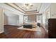 Spacious main bedroom with a tray ceiling, wood floors, and a sitting area at 5073 Kingsbridge Pass, Powder Springs, GA 30127