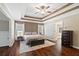 Beautiful main bedroom featuring a tray ceiling, wood floors, and access to the bathroom at 5073 Kingsbridge Pass, Powder Springs, GA 30127