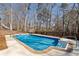 Backyard in-ground pool with diving board, fencing, and mature trees at 5073 Kingsbridge Pass, Powder Springs, GA 30127