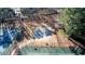 Overhead shot of community basketball and tennis courts, fenced and surrounded by tall trees at 5073 Kingsbridge Pass, Powder Springs, GA 30127