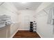 Walk-in closet featuring built-in shelving for optimal storage and organization at 5073 Kingsbridge Pass, Powder Springs, GA 30127