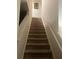 Carpeted staircase with neutral-colored walls and railings at 5396 Pennington Court, Atlanta, GA 30349