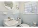 Charming light blue tiled bathroom with pedestal sink at 571 Allgood Ne Rd, Marietta, GA 30060