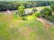 Scenic aerial shot of the estate, showcasing the main house, horse paddocks, and well-kept grounds at 1820 Walker Sw Rd, Conyers, GA 30094