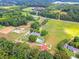 Complete aerial view of the horse farm, including paddocks, main home, and surrounding landscape at 1820 Walker Sw Rd, Conyers, GA 30094