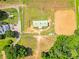 Aerial perspective showing the horse barn and riding area, with green pastures and landscaping at 1820 Walker Sw Rd, Conyers, GA 30094