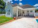 A home backyard features covered porch, patio, lawn, and partial view of a pool at 1820 Walker Sw Rd, Conyers, GA 30094