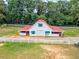 Bright white barn with a vibrant red roof and open lean-to at 1820 Walker Sw Rd, Conyers, GA 30094