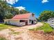 Exterior shot of barn with red roof, horse stalls, sliding doors, and mature landscaping at 1820 Walker Sw Rd, Conyers, GA 30094