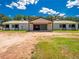 Spacious barn exterior featuring multiple stalls and green doors, creating a functional equestrian facility at 1820 Walker Sw Rd, Conyers, GA 30094