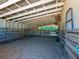 Interior view of a barn stall with wooden beams, dirt floor, and metal gate at 1820 Walker Sw Rd, Conyers, GA 30094