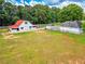 Spacious red barn with a white exterior, set on a large lot at 1820 Walker Sw Rd, Conyers, GA 30094