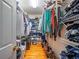 Walk-in closet featuring built in shelving with ample storage and hardwood floors at 1820 Walker Sw Rd, Conyers, GA 30094