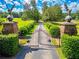 Grand gated entrance to horse property with mature trees lining the long driveway, topped with eagle statues at 1820 Walker Sw Rd, Conyers, GA 30094