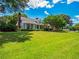 Beautiful home featuring a sprawling lawn, mature trees, and classic architectural details at 1820 Walker Sw Rd, Conyers, GA 30094