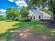 Lovely exterior of home with expansive lawn, manicured landscaping, and attached garage at 1820 Walker Sw Rd, Conyers, GA 30094