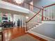 Beautiful foyer with hardwood floors, staircase and a view into the dining and living spaces at 1820 Walker Sw Rd, Conyers, GA 30094