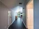 Hallway with light gray walls leading to a living space with a fireplace and TV at 1820 Walker Sw Rd, Conyers, GA 30094