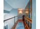 Bright hallway with hardwood floors and a large built-in bookcase with glass doors at 1820 Walker Sw Rd, Conyers, GA 30094