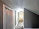 Long gray hallway with a textured ceiling and multiple doors at 1820 Walker Sw Rd, Conyers, GA 30094