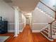 Hallway with hardwood floors, columns, and a view of the staircase at 1820 Walker Sw Rd, Conyers, GA 30094