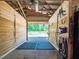 Interior view of horse stalls with rubber mat flooring and access to outdoor paddock area at 1820 Walker Sw Rd, Conyers, GA 30094