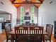 View of the living room, featuring a cathedral ceiling, fireplace, and a dining table at 1820 Walker Sw Rd, Conyers, GA 30094