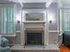 Charming living room featuring a fireplace with a decorative mantle and shuttered windows at 1820 Walker Sw Rd, Conyers, GA 30094