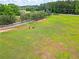 Beautiful acreage with a white fence, perfect for horses to roam and graze at 1820 Walker Sw Rd, Conyers, GA 30094