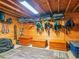 Well-equipped tack room featuring wooden storage trunks, shelving, and hooks for horse gear at 1820 Walker Sw Rd, Conyers, GA 30094