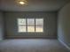 Spacious bedroom with a large window showcasing views of surrounding trees at 3292 Lions Ruby Ln, Atlanta, GA 30349