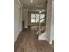 Inviting foyer with wood-look flooring, an elegant staircase, and plenty of natural light at 3292 Lions Ruby Ln, Atlanta, GA 30349